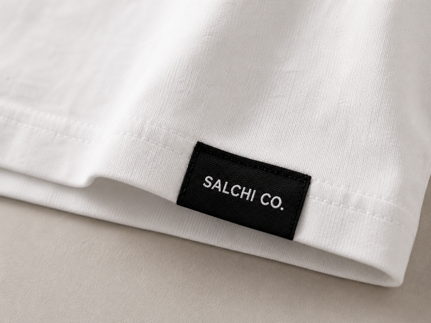 Etiqueta premium SALCHI CO en crop top blanco